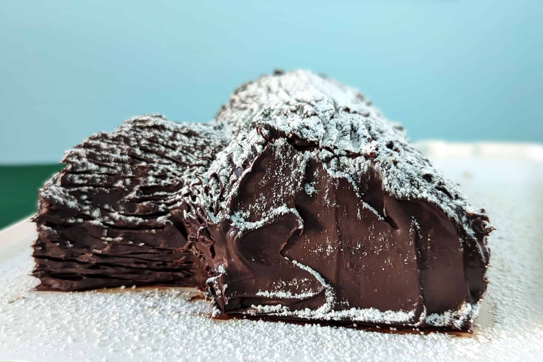 flourless chocolate yule log, dusted with powdered sugar snow