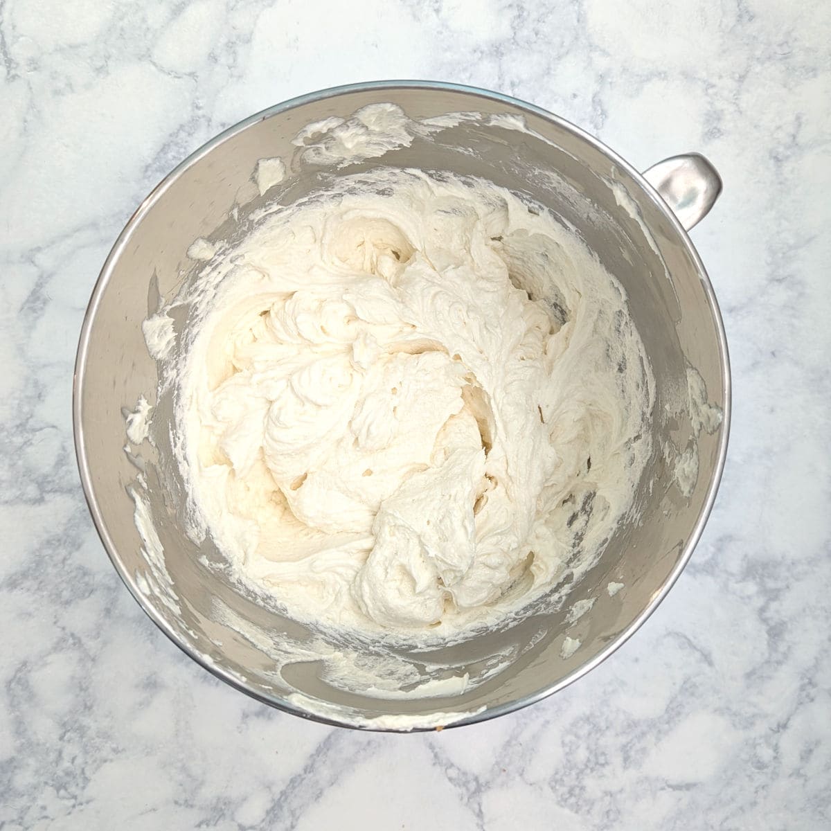 Ermine frosting, fully beaten, in the bowl of a stand mixer.
