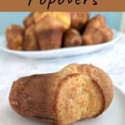 A whole and uncut popover on a plate, in front of a platter of popovers. Text overlay for Pinterest reads: Martha Stewart's Popovers. Just 4 ingredients! Made straight from the fridge!