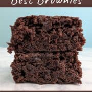 Two brownies stacked on top of each other. Text overlay for Pinterest reads: "Hershey's Best Brownies. Made with Cocoa Powder. A One-Bowl Recipe!"