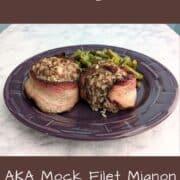 Two Fake Steak patties, wrapped in bacon, alongside green beans, on a purple plate. Text overlay for Pinterest reads "Fake Steak. AKA Mock Filet Mignon. Just 6 Ingredients!"