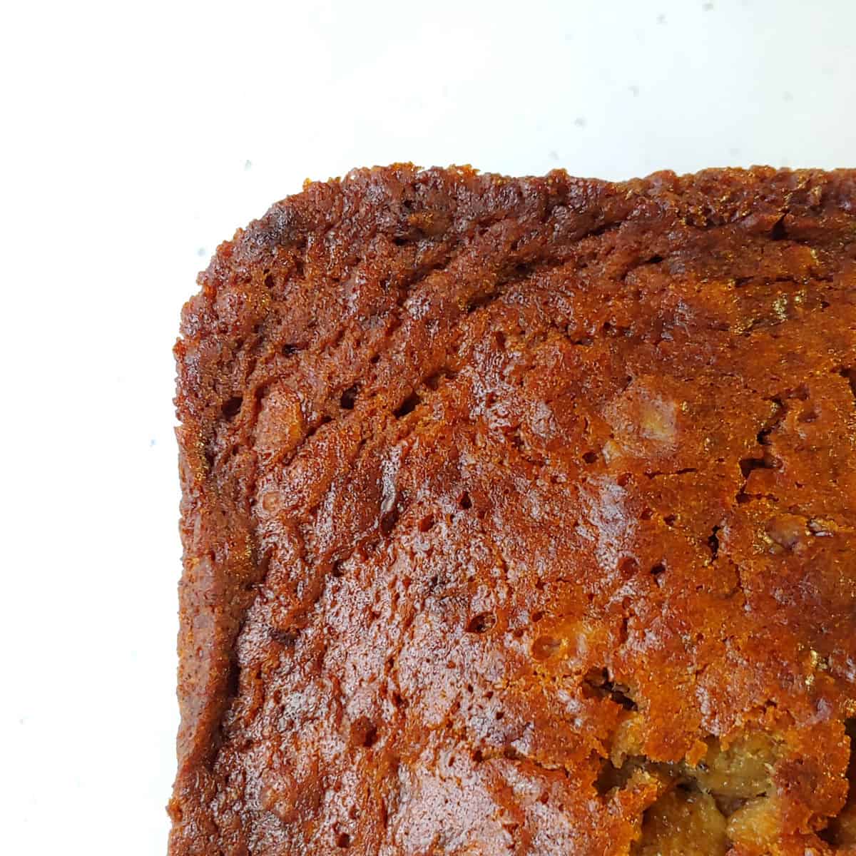 A close-up of banana bread's top and edge crust.