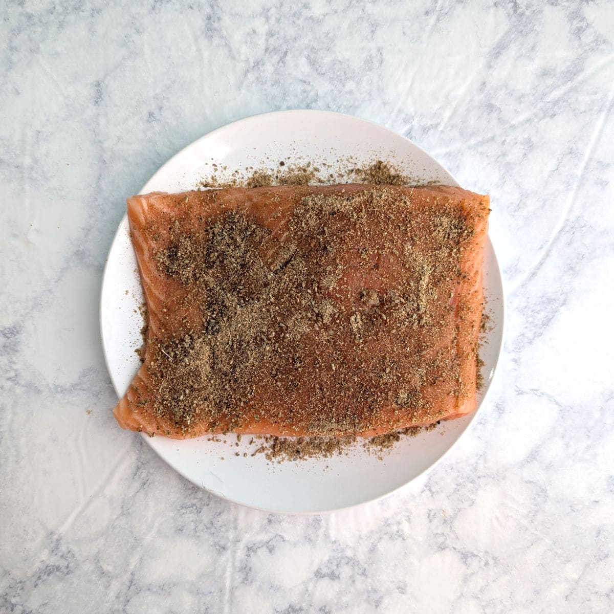 Fennel spice rub, on a piece of raw salmon.