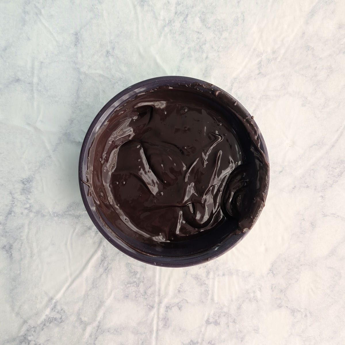 Chocolate ganache in a purple bowl.