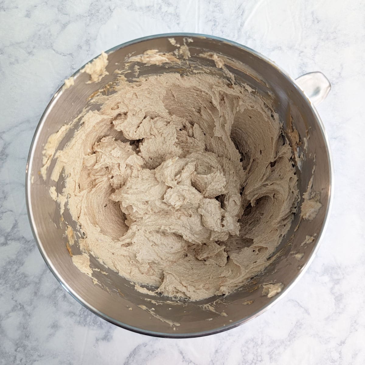 Whipped cream cheese, peanut butter, and sugar, in a stand mixer bowl.