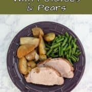 Slices of fennel-crusted pork, with green beans and roasted potatoes, pears, and onions, on a plate. Text overlay for Pinterest reads "Fennel Pork Loin with Potatoes and Pears."
