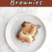 A s'mores brownie, on a plate. Text overlay for Pinterest reads "S'mores Brownies."