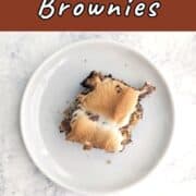 A s'mores brownie, on a plate. Text overlay for Pinterest reads "S'mores Brownies. Gooey & Sweet!"