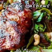 A grilled sirloin steak on a bed of salad greens topped with cashews. Text overlay for Pinterest reads "Steak Salad with Lime & Cashews. No Cheese. No Vinegar."