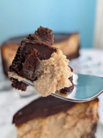 A bite of chocolate peanut butter cheesecake, on a fork.