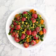 Corn and green bean salad with tomatoes and cilantro on top.