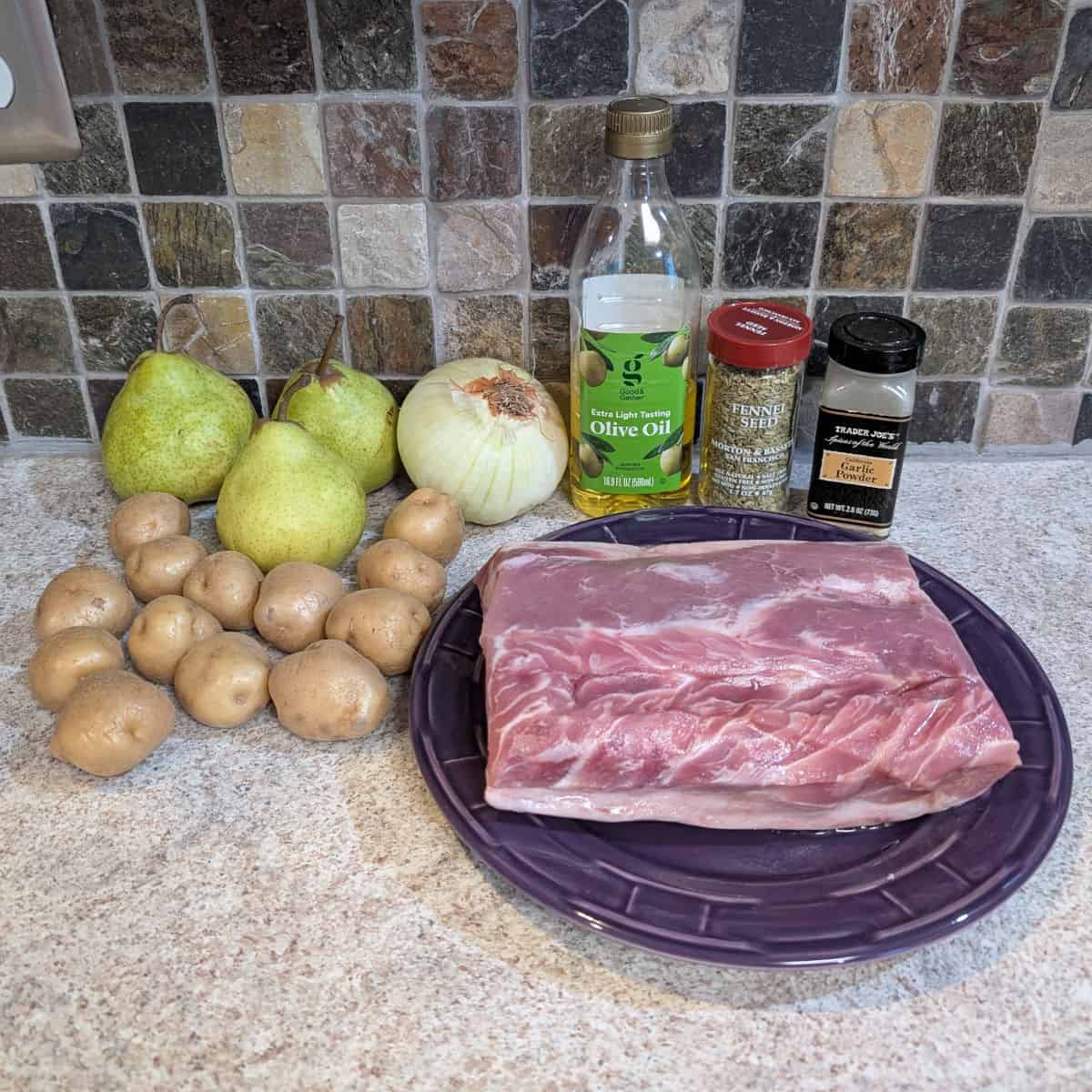 Pears, an onion, olive oil, fennel seed, garlic powder, small potatoes, and pork loin.