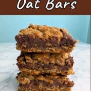 A stack of 3 chocolate oat bars on a plate. Text overlay for Pinterest reads "Chocolate Oat Bars. Rich and Decadent!"