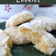 Gooey butter cookies on a plate, with one torn open to show texture.