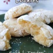 Gooey butter cookies on a plate, with one torn open to show texture.