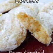 Gooey butter cookies on a plate, with one torn open to show texture.