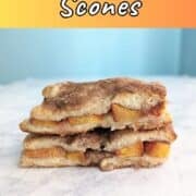 Two stacked peach cobbler scones. Text overlay for Pinterest reads "Peach Cobbler Scones. Sweet & Delicious!"