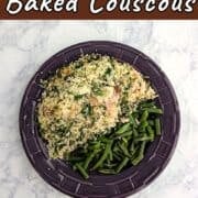 Salmon with Baked Couscous, alongside green beans on a purple plate.