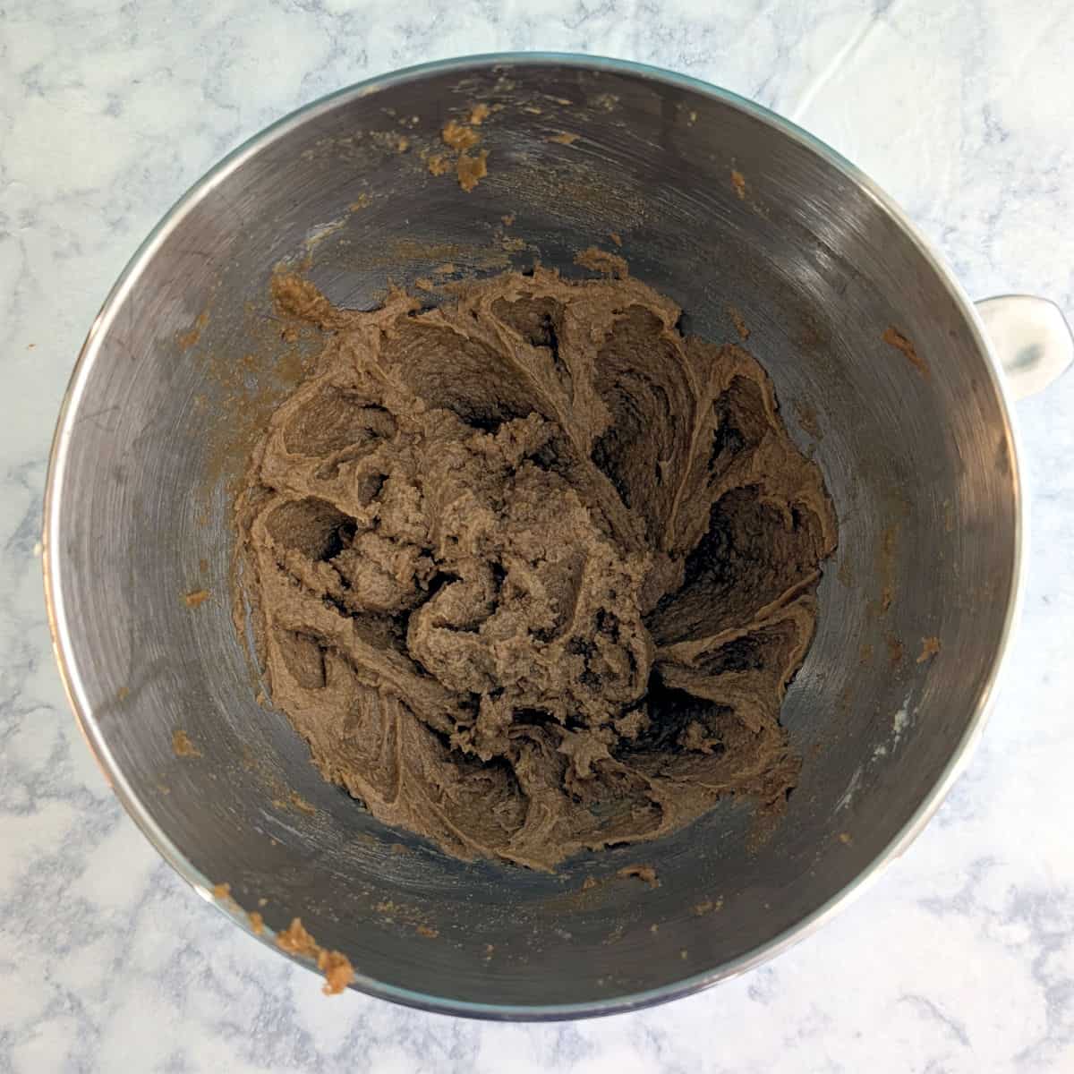 Butter, brown sugar, eggs, and vanilla, beaten together, in a stand mixer bowl.