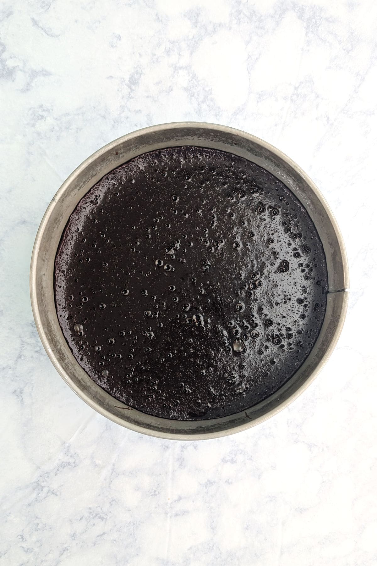 Chocolate truffle cake, fully baked, in a Springform pan.