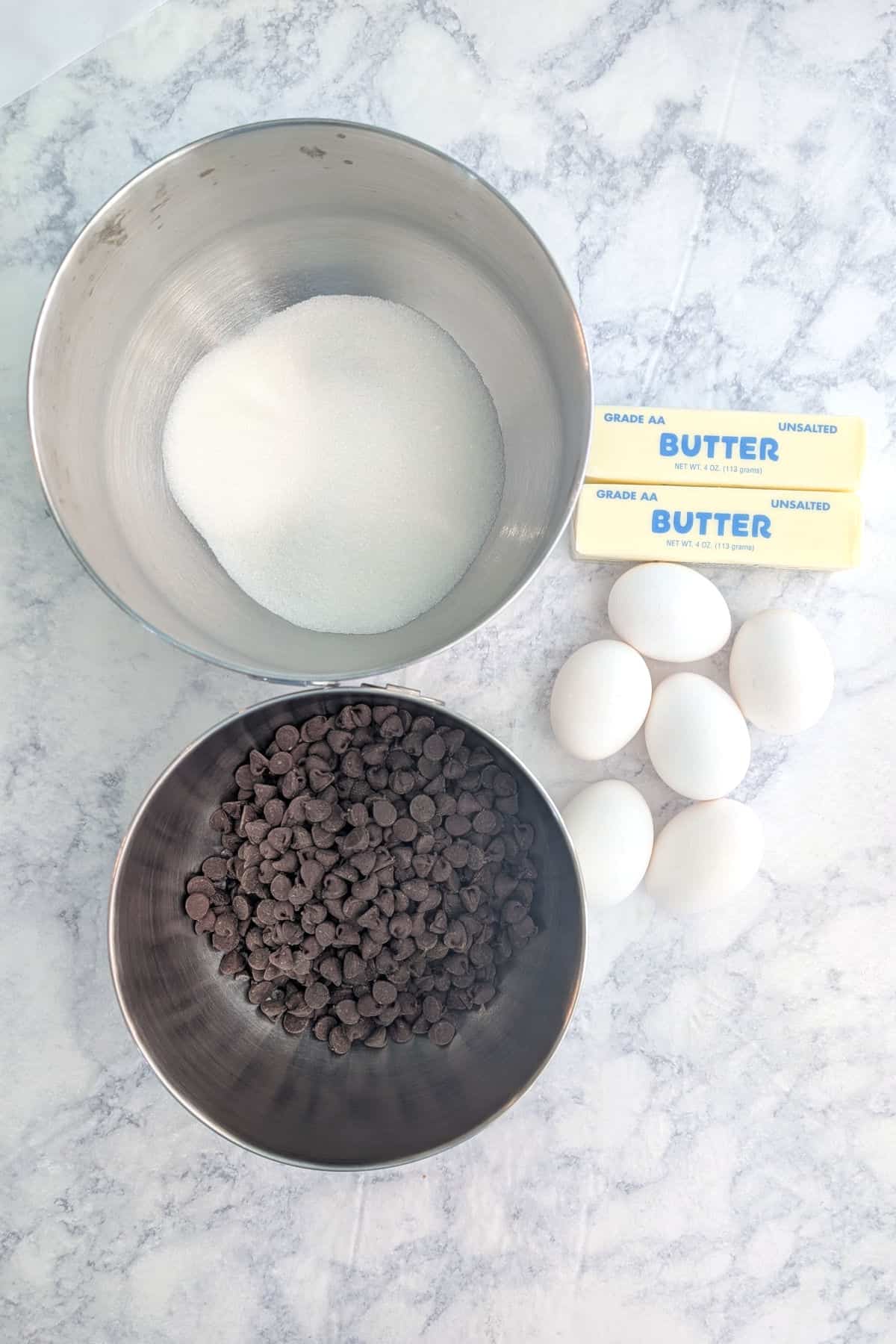 Ingredients for chocolate truffle cake: sugar, butter, eggs, and chocolate.