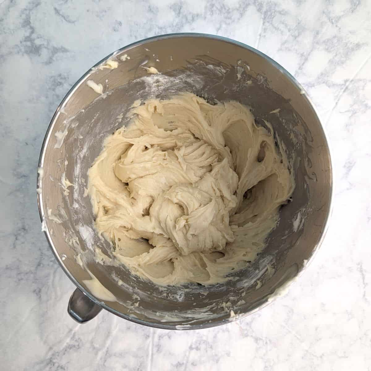 Gooey butter cookie batter, in a stand mixer bowl.