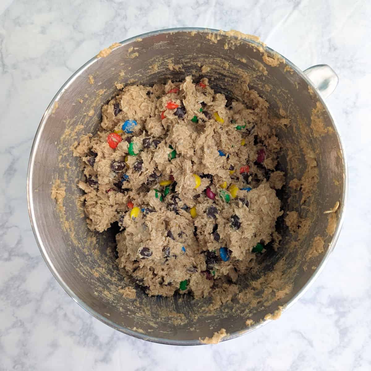 Monster cookie dough, in a stand mixer bowl.