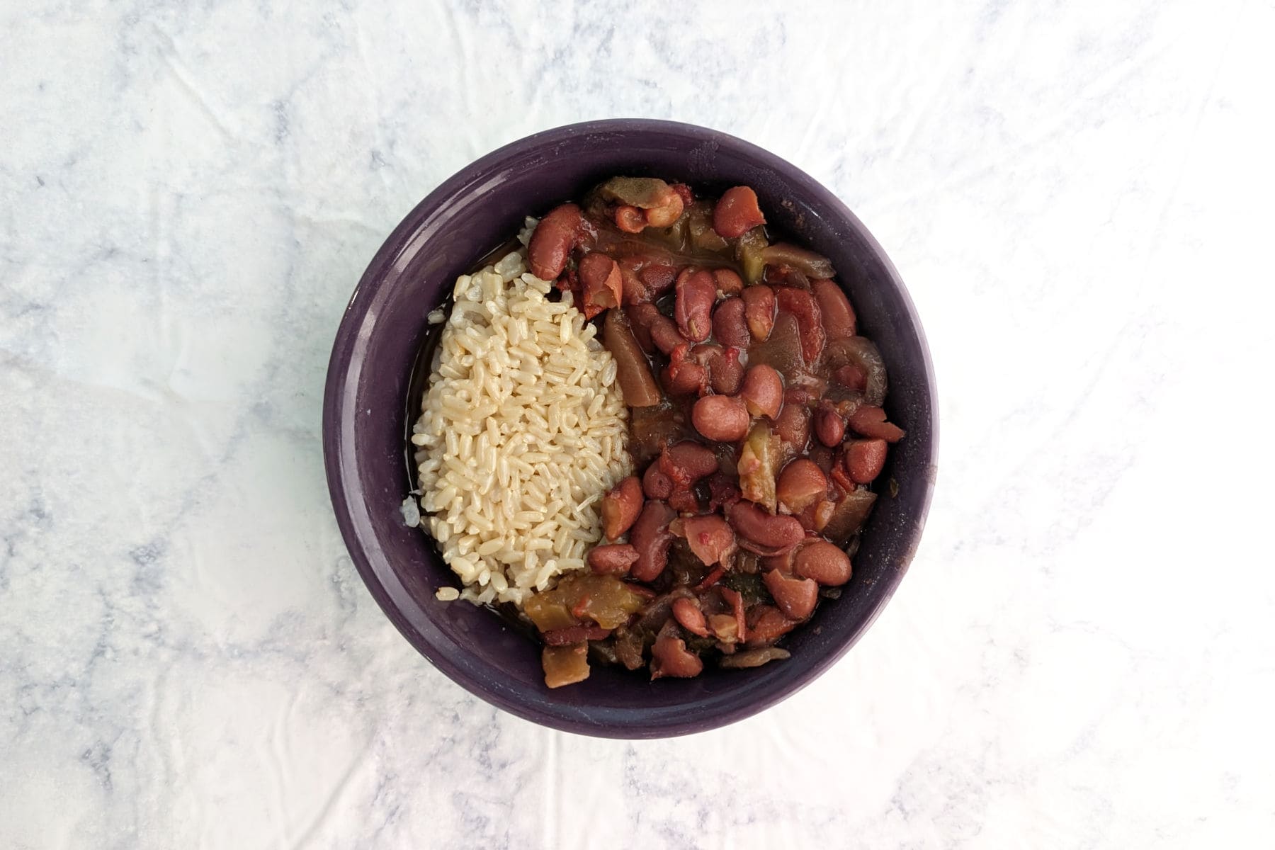 Vegetarian Slow Cooker Red Beans and Rice, in a purple bowl.