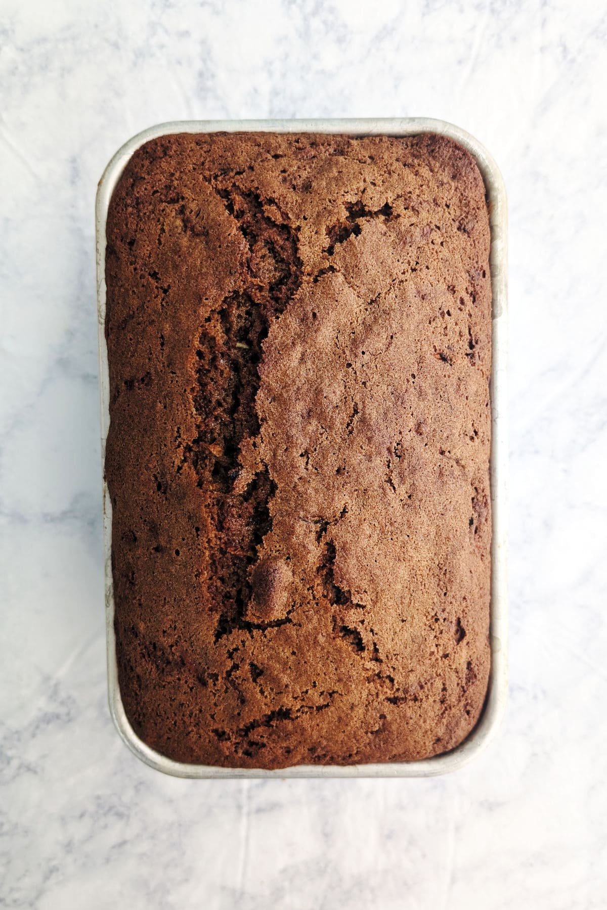 Baked zucchini bread, in a loaf pan.