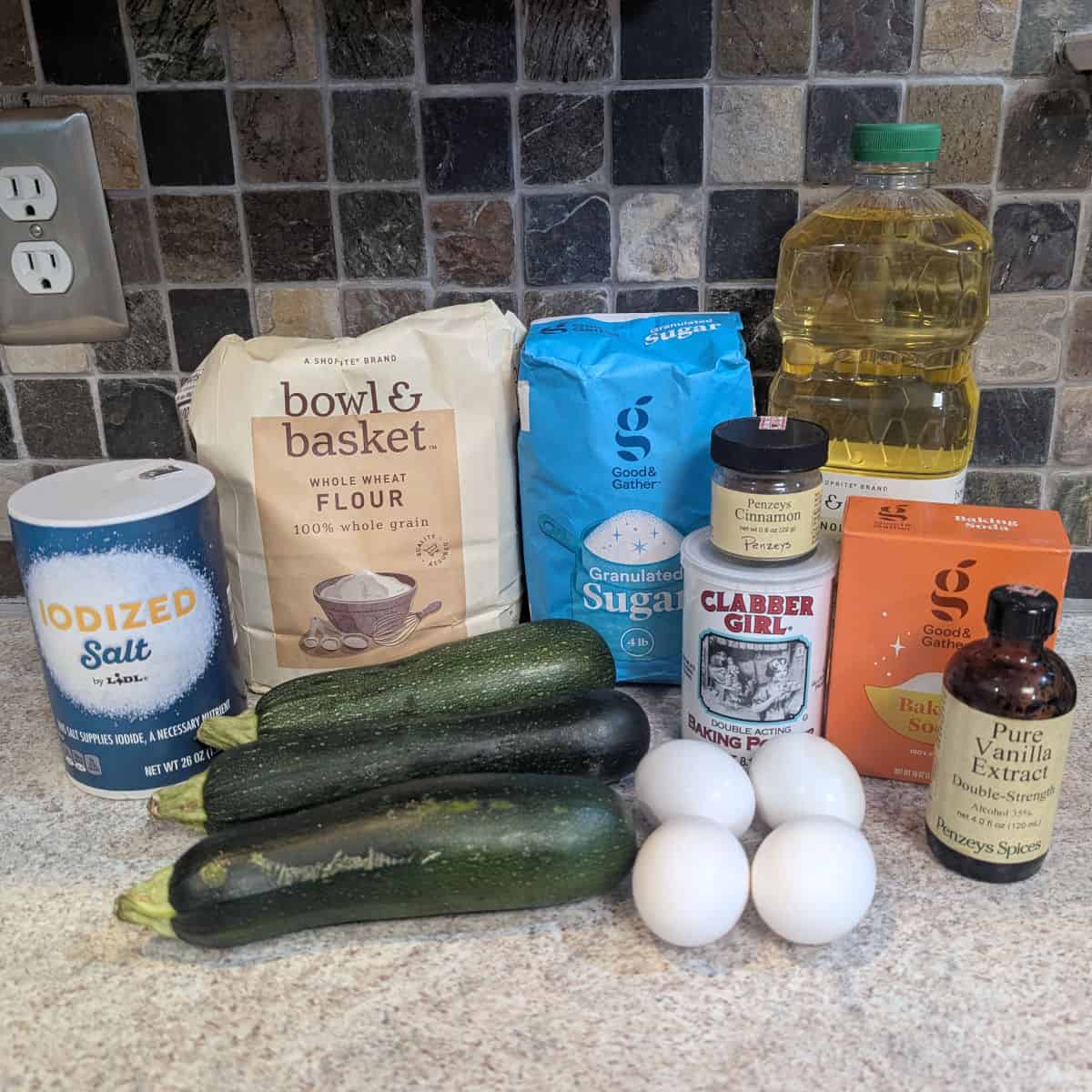 Ingredients for whole wheat zucchini bread: whole wheat flour, sugar, vegetable oil, baking soda, baking powder, salt, cinnamon, vanilla, eggs, and 3 small zucchini.