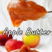 A spoon filled with apple butter. Text overlay for Pinterest reads "Slow Cooker Apple Butter. No Sugar Added!"
