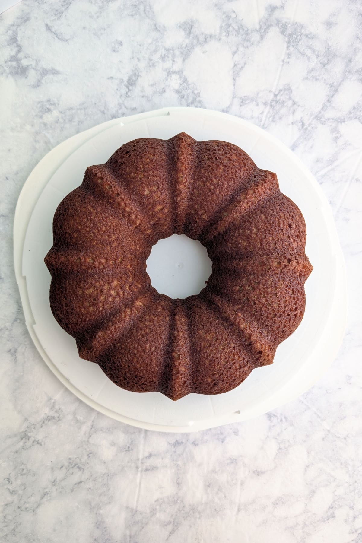 Apple cider donut cake, turned out onto a cake platter.