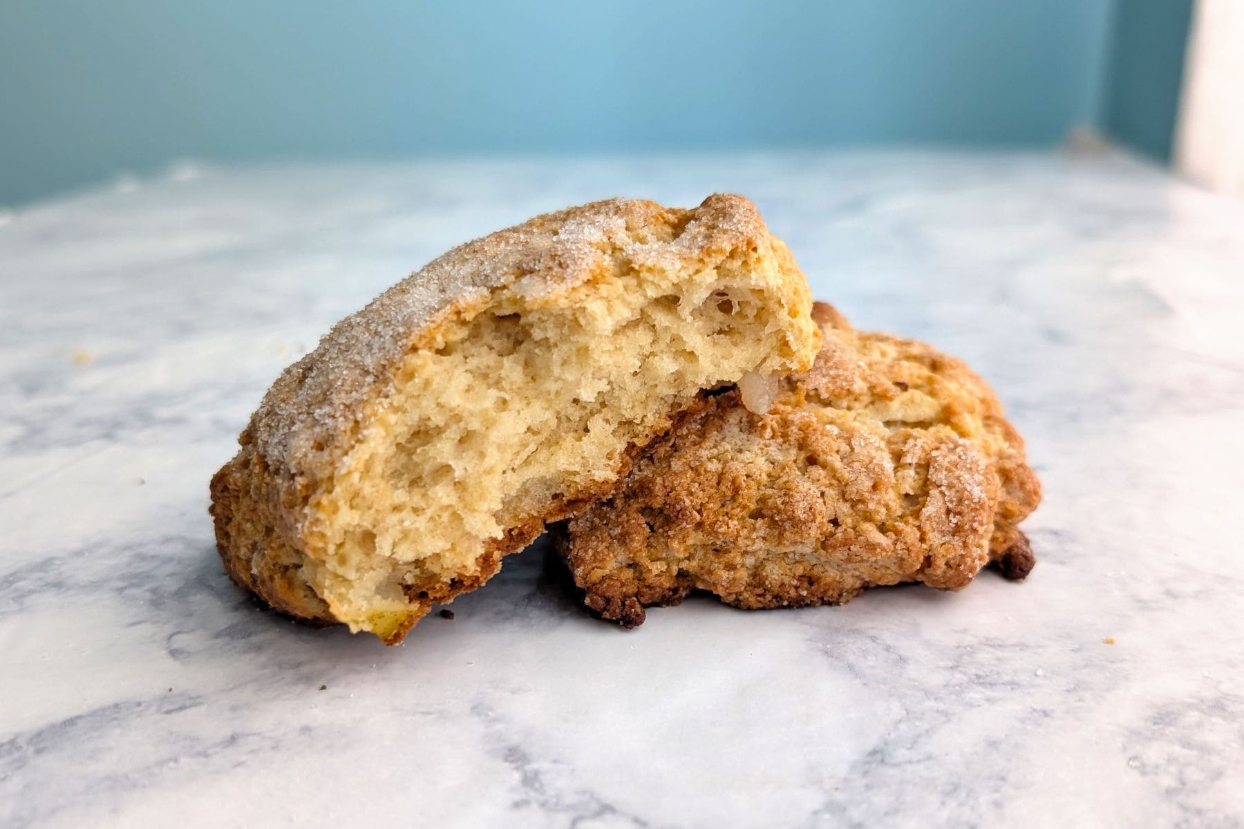 An apple and pear scone, split open to show texture.