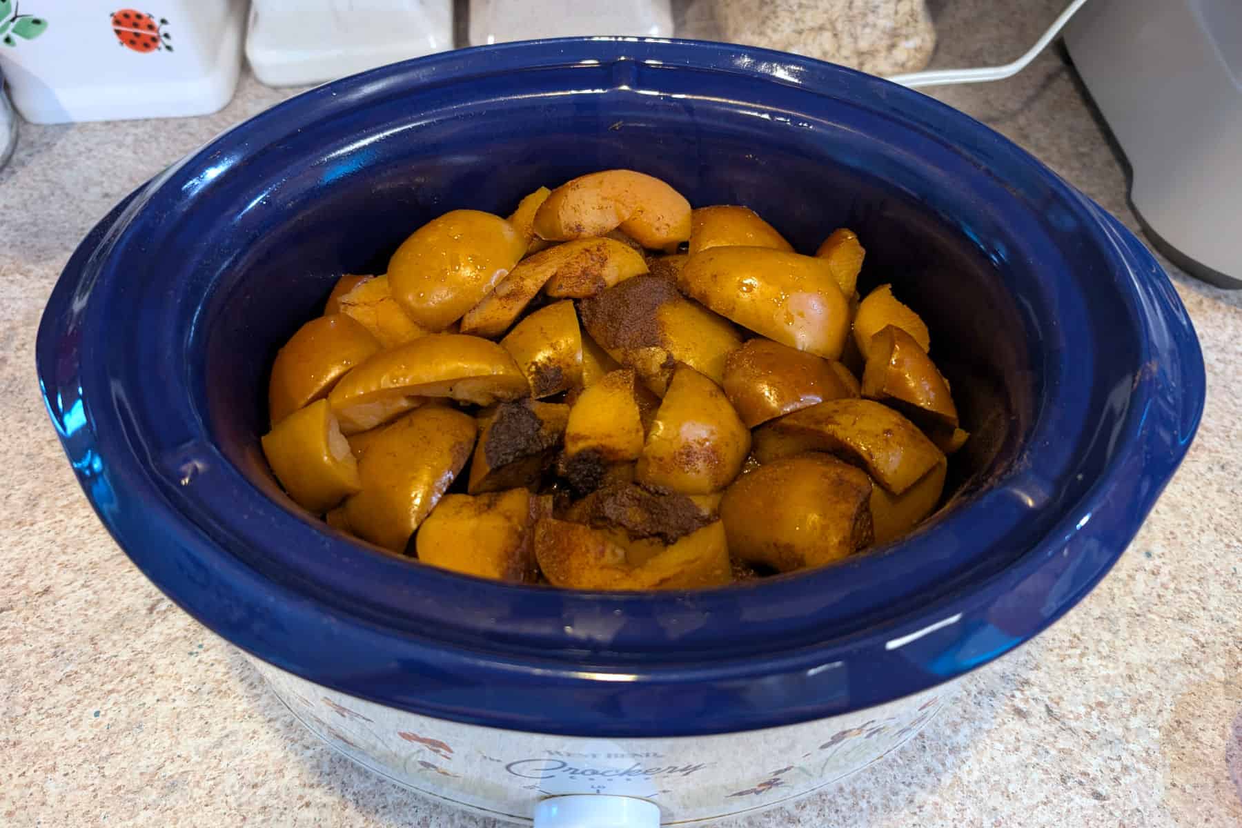 Cooked apples with spices in a 3.5 quart slow cooker.