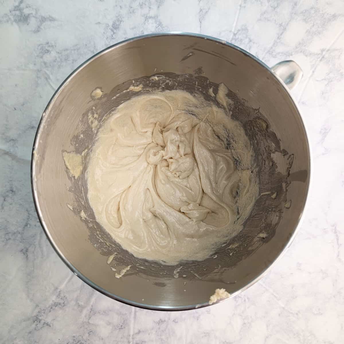 Creamed butter, sugars, eggs, and oil, in a stand mixer bowl.
