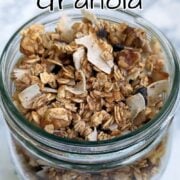 Aquafaba granola with oats, coconut, walnuts, and cinnamon, in a glass jar. Text overlay for Pinterest reads, "Aquafaba Granola. Vegan & Oil-Free! Easy As Cookies."