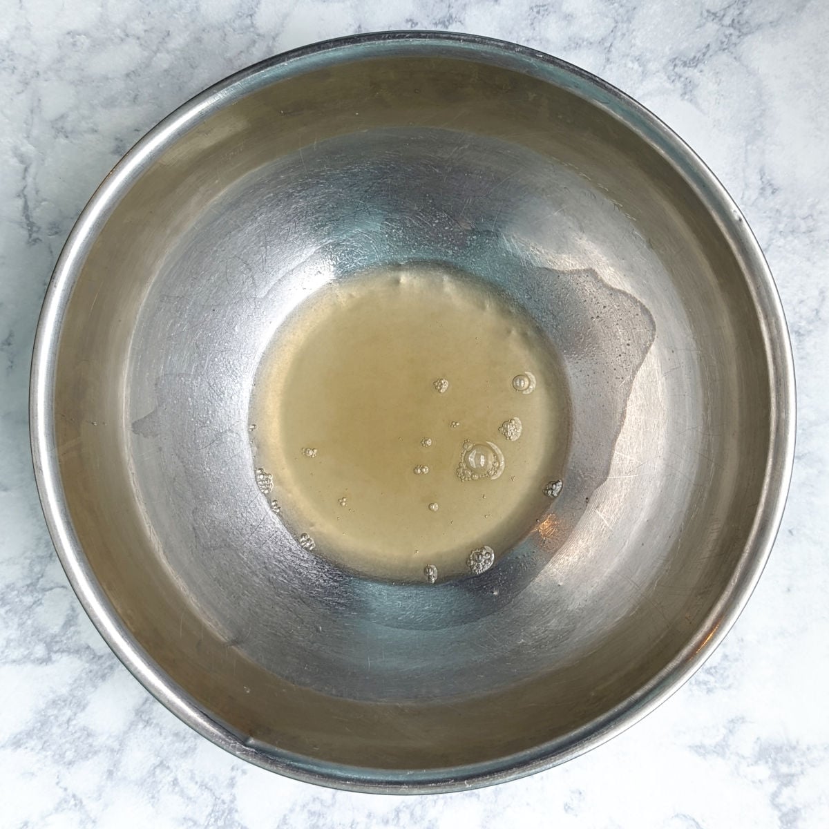 Aquafaba in a large mixing bowl, before whipping.