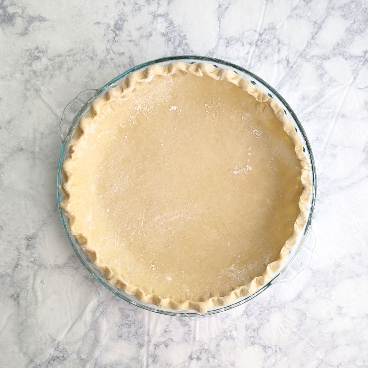 Pie crust, shaped and in a deep dish pie pan, before baking.