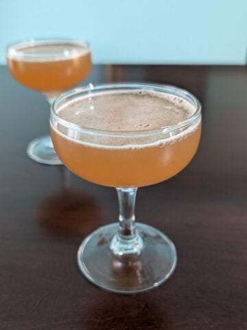 Whiskey sherry cocktail, in two couple glasses.