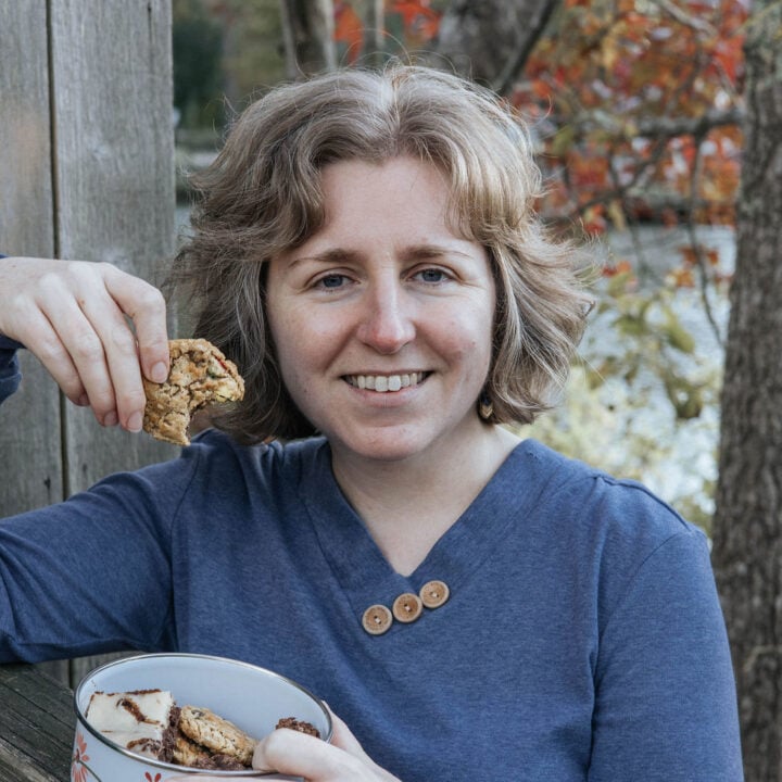 Leona Konkel, of Easy As Cookies, holds a cookie with a bite missing. Photo credit: Heart from Home Photography.