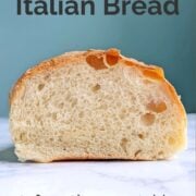 A slice of Peter Reinhart's Italian Bread, shown from the side to see the airy texture. Text overlay reads "Homemade Italian Bread. Soft, chewy, golden. Easy As Cookies."