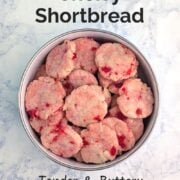 A bowl of white chocolate cherry shortbread cookies. Text overlay reads "White Chocolate Cherry Shortbread. Tender & Buttery. No-Chill Dough. Easy As Cookies."