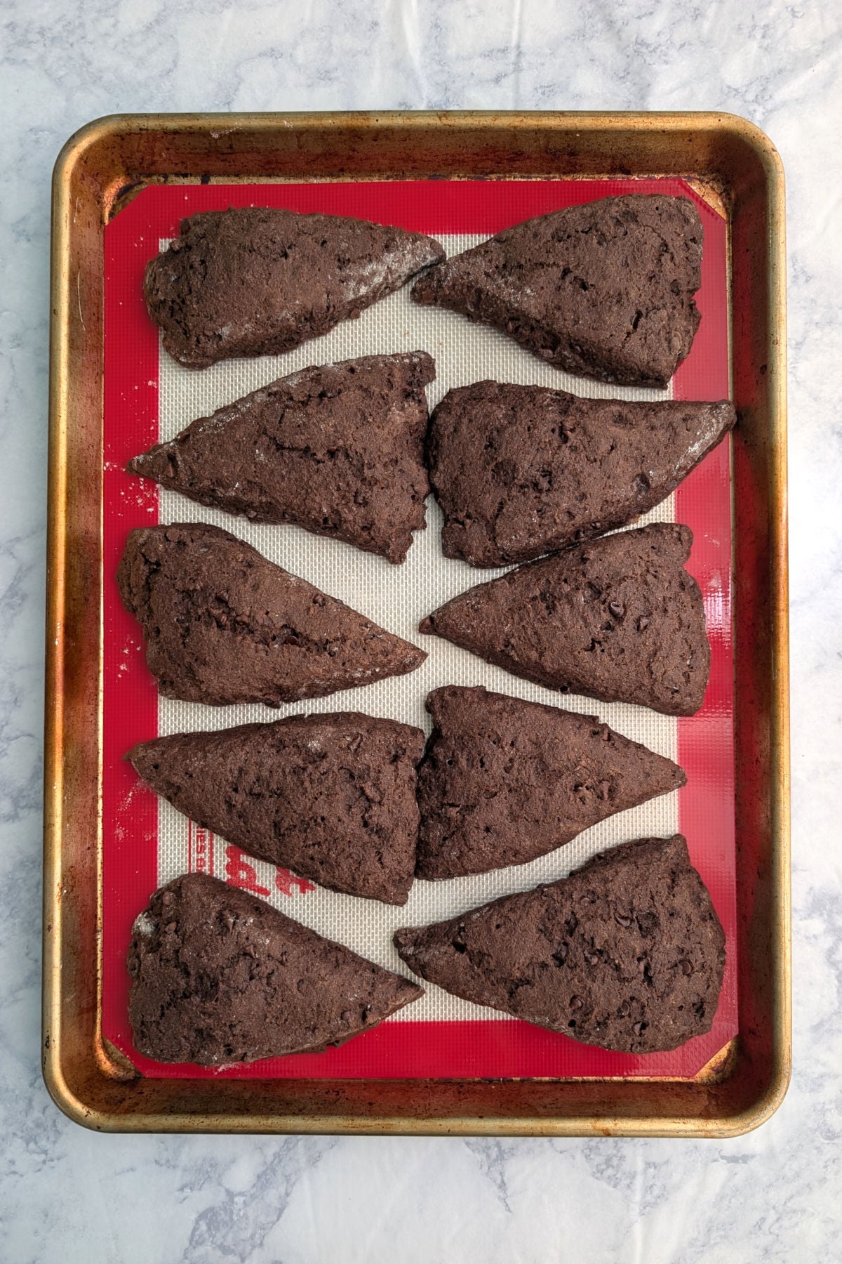 Double chocolate scones, baked, on a baking sheet.