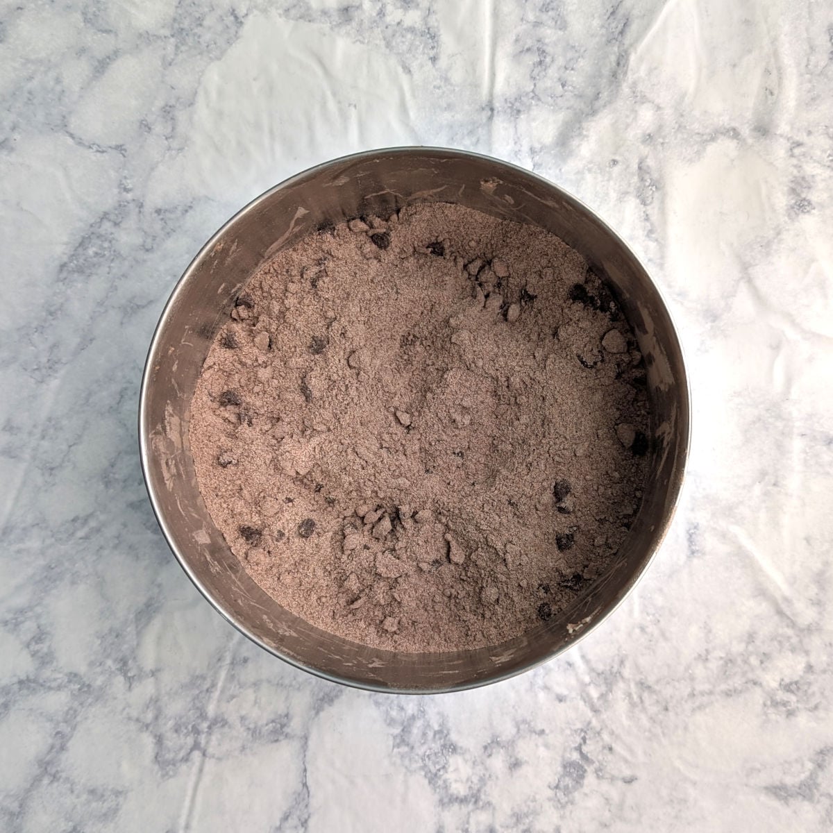 Flour-cocoa mixture for double chocolate scones, with mini chocolate chips and butter mixed in.