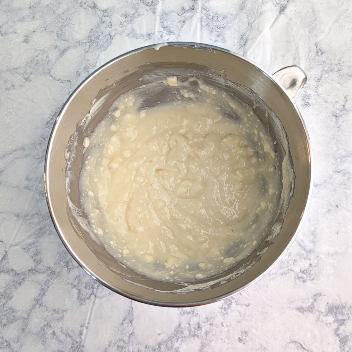 Butter, ricotta, and sugar, creamed together in a stand mixer bowl.