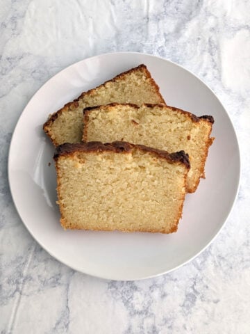 Three slices of ricotta pound cake, on a plate.