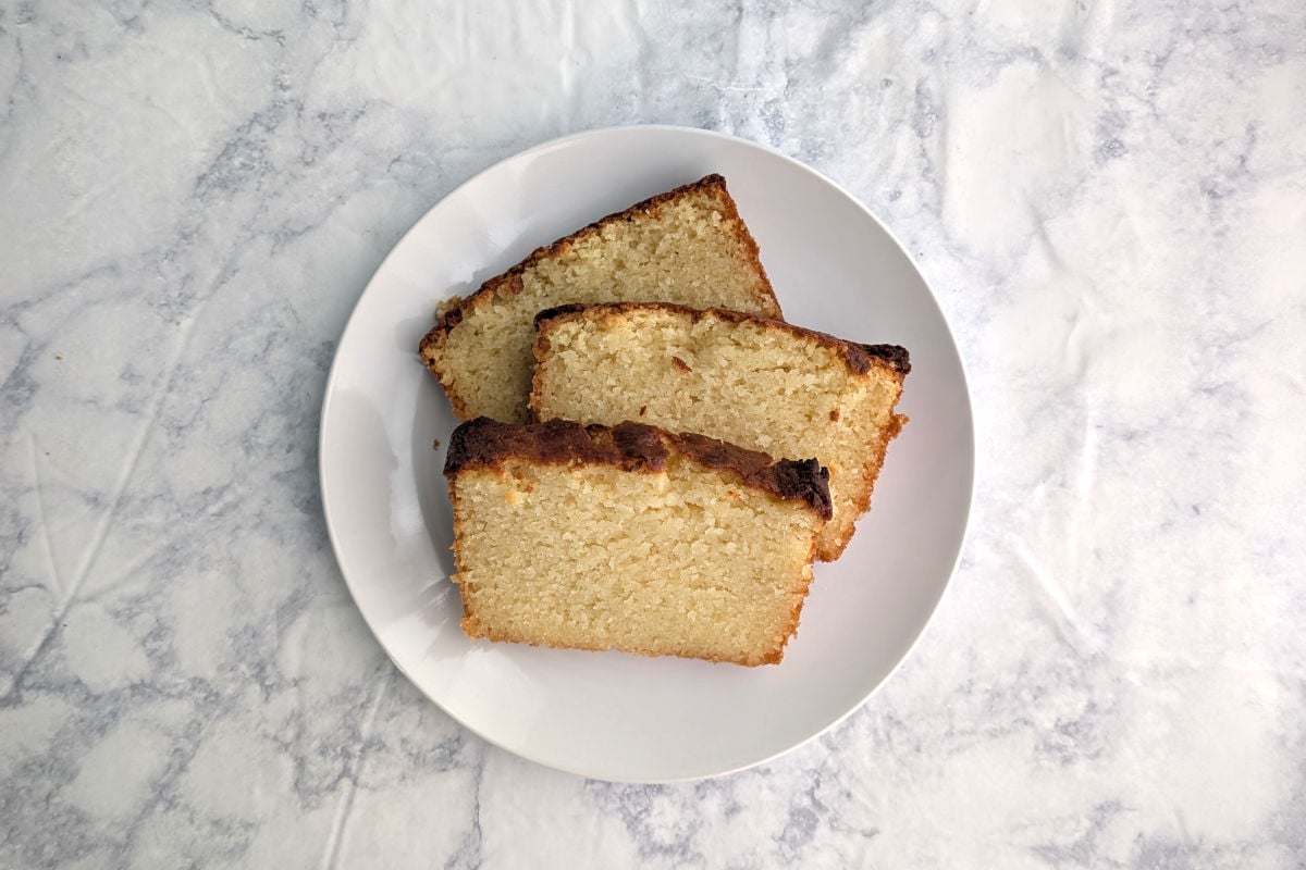Three slices of ricotta pound cake, on a plate.