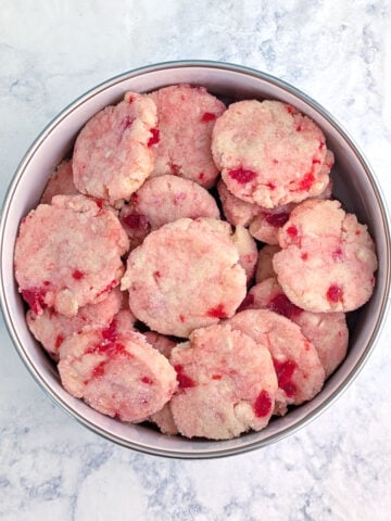 A bowl of white chocolate cherry shortbread cookies.