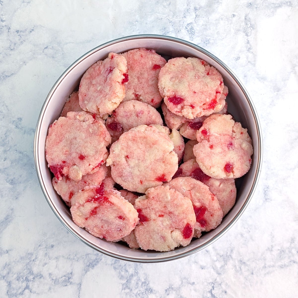 A bowl of white chocolate cherry shortbread cookies.