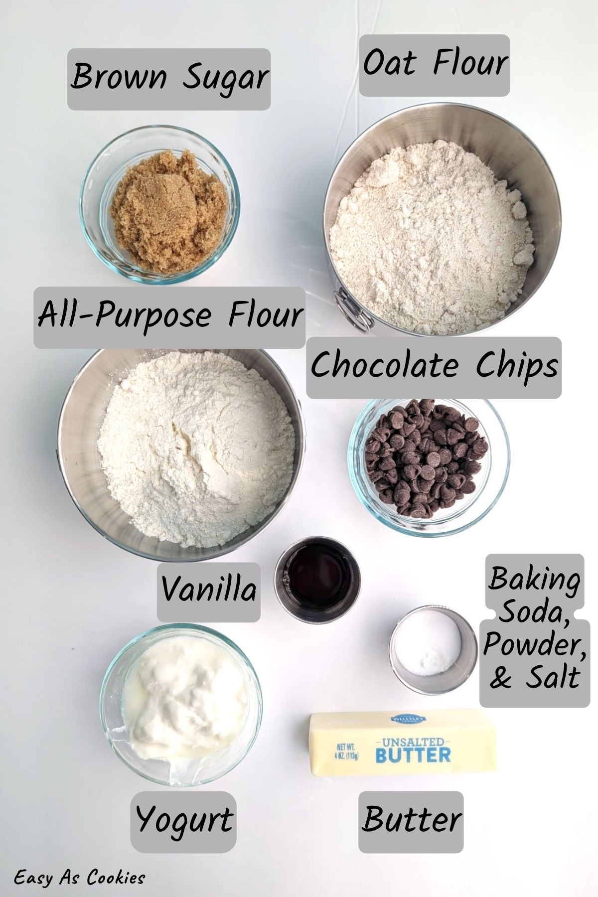 Ingredients for chocolate chip cookie scones, including brown sugar, oat flour, all-purpose flour, vanilla, chocolate chips, baking soda, baking powder, table salt, yogurt, and unsalted butter.